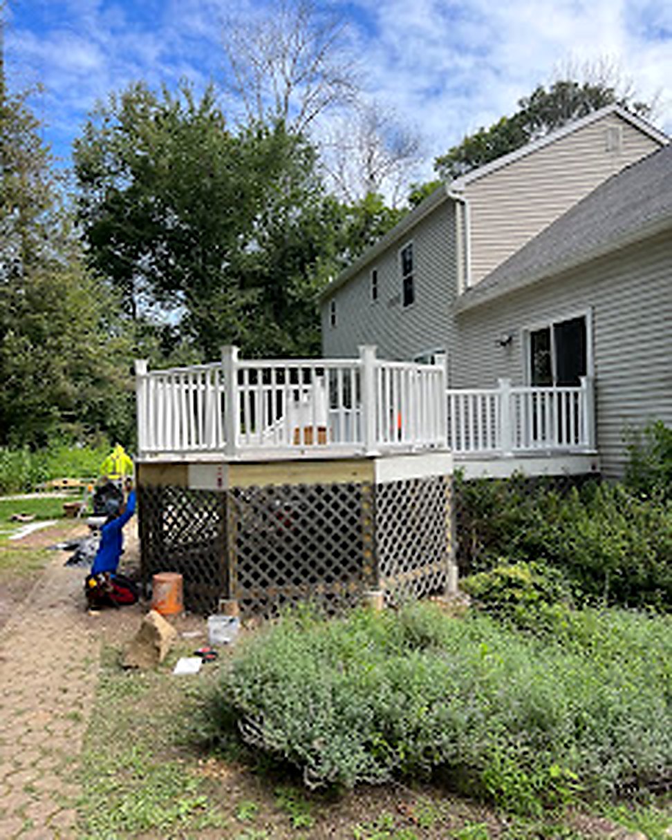 Crew in safety vests installing custom deck in Central NJ